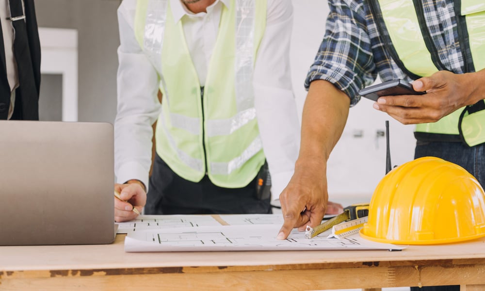 stock-photo-diverse-team-of-specialists-use-tablet-computer-on-construction-site-real-estate-building-project-2280963481