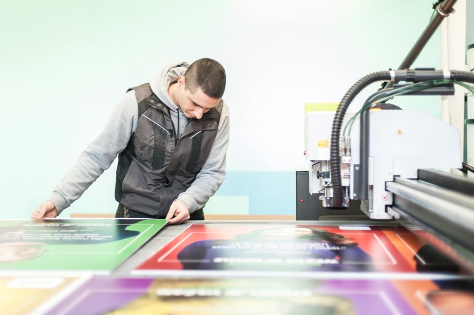 stock-photo-printshop-worker-technician-works-on-large-cnc-computer-numerical-control-printing-and-cutting-167812472