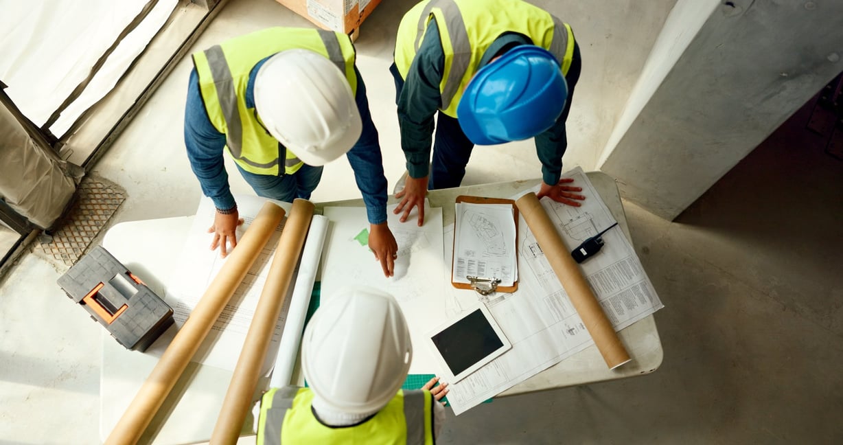 stock-photo-top-view-team-and-construction-for-blueprint-building-collaboration-or-talking-for-business-2269865641
